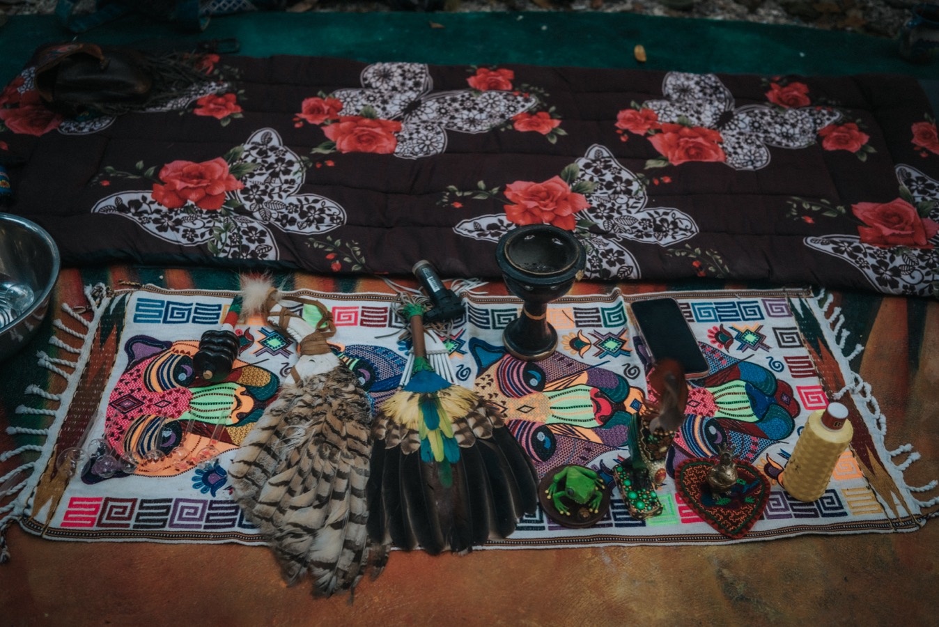 A medicine altar laid out on an embroidered cloth