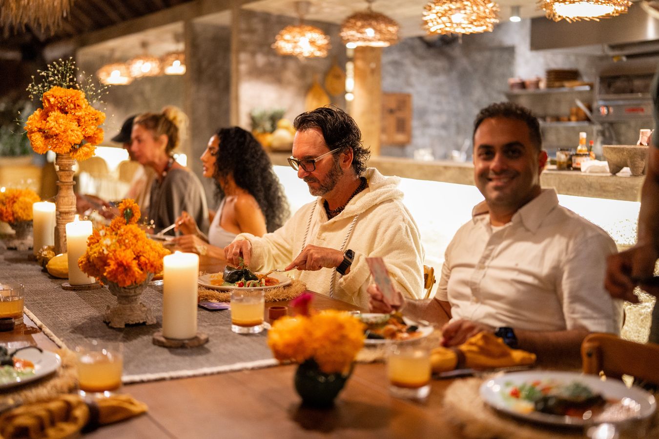 The group sharing a candlelit dinner together