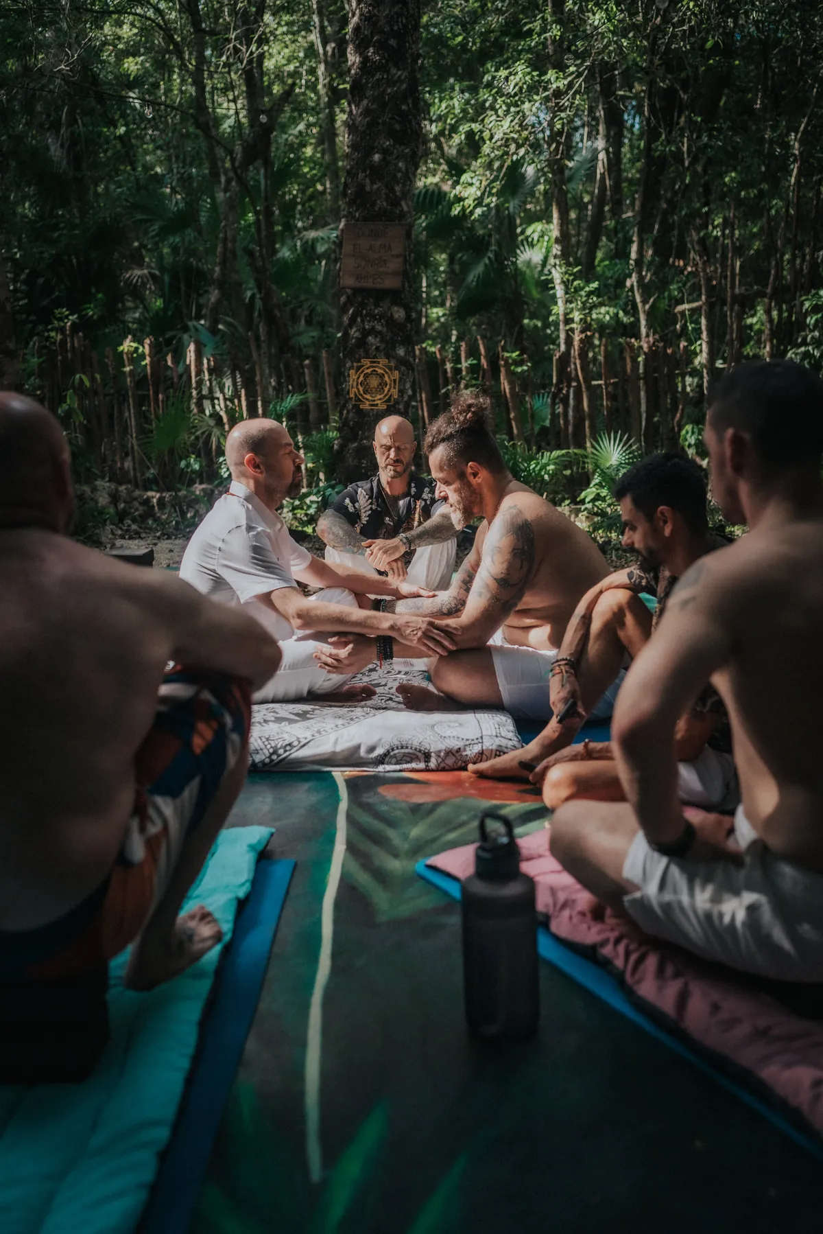 A ceremony circle gathered in the jungle at a Tiger Soul retreat