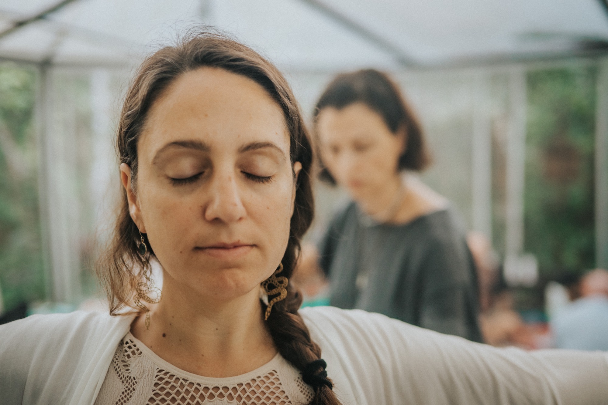 A woman resting with her eyes closed in a quiet moment of integration