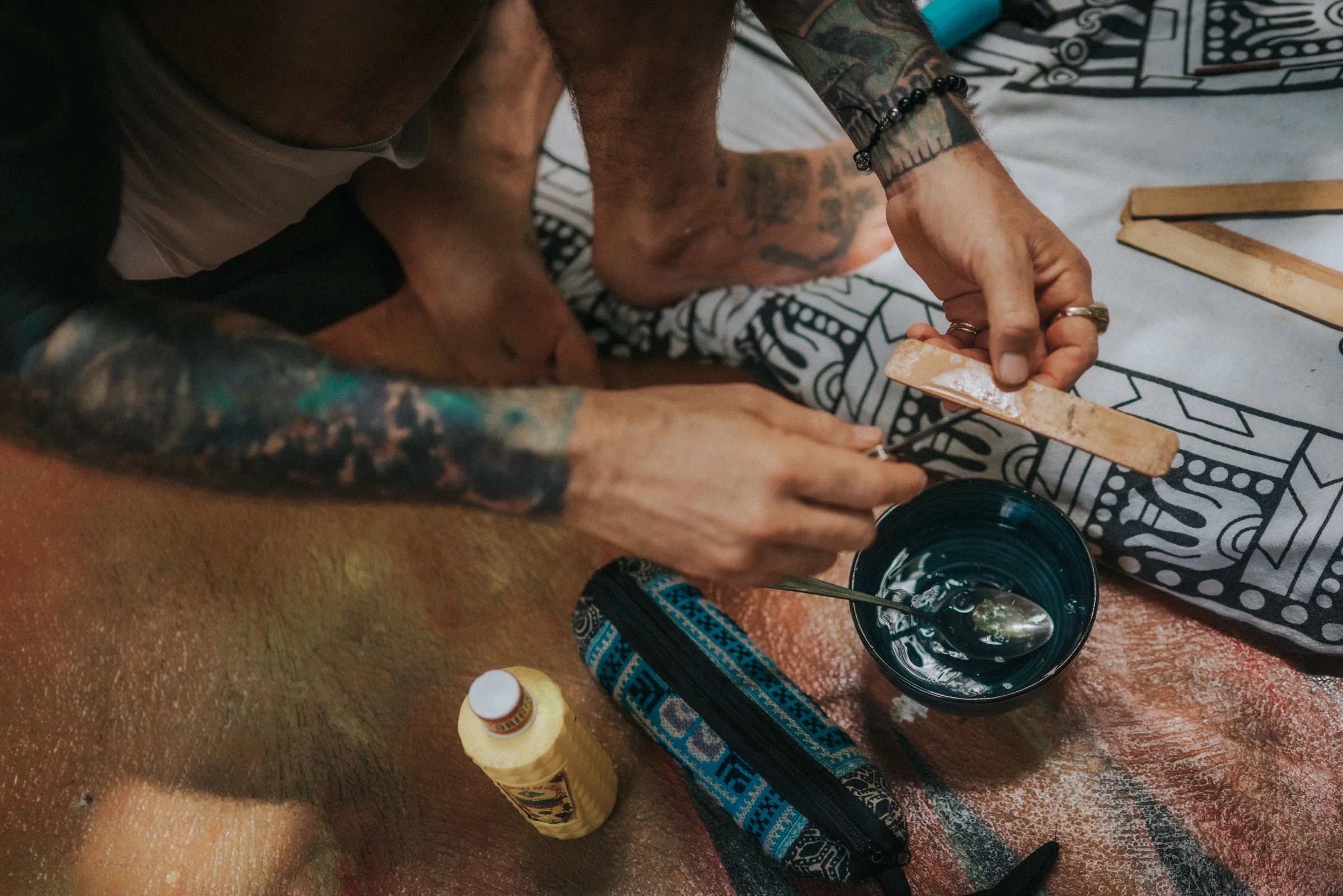 Hands preparing the sacred medicine over a ceremonial cloth