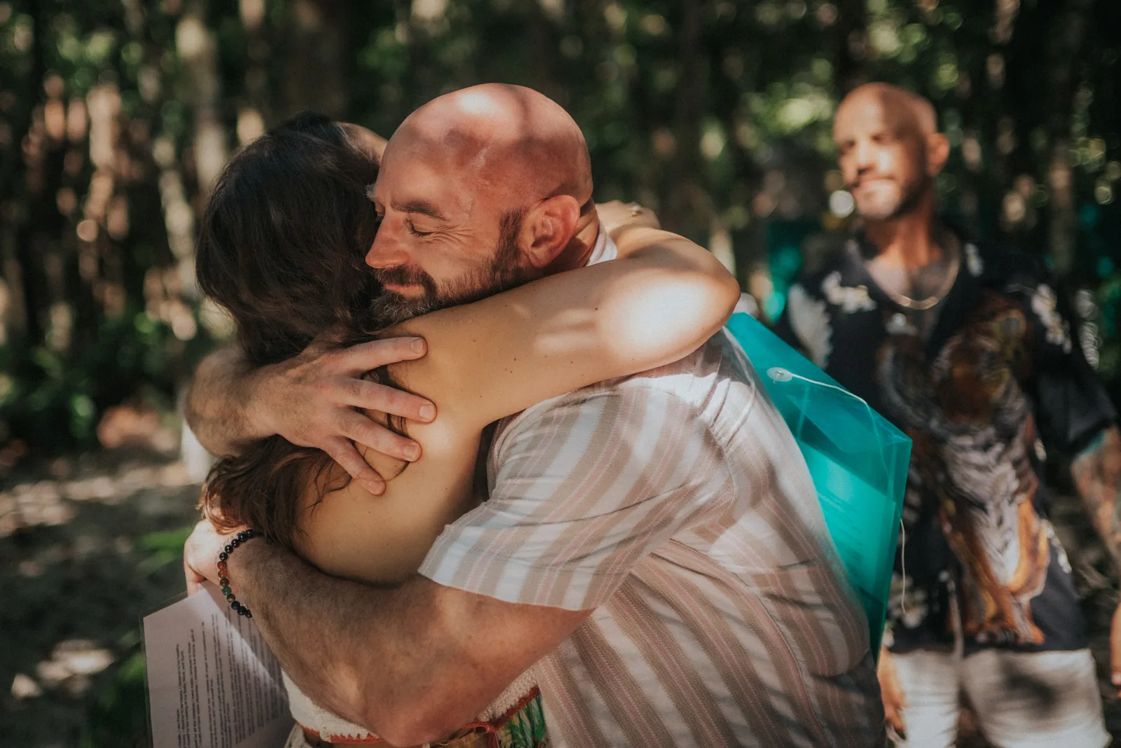 Two people embracing at a Tiger Soul ceremony in the jungle