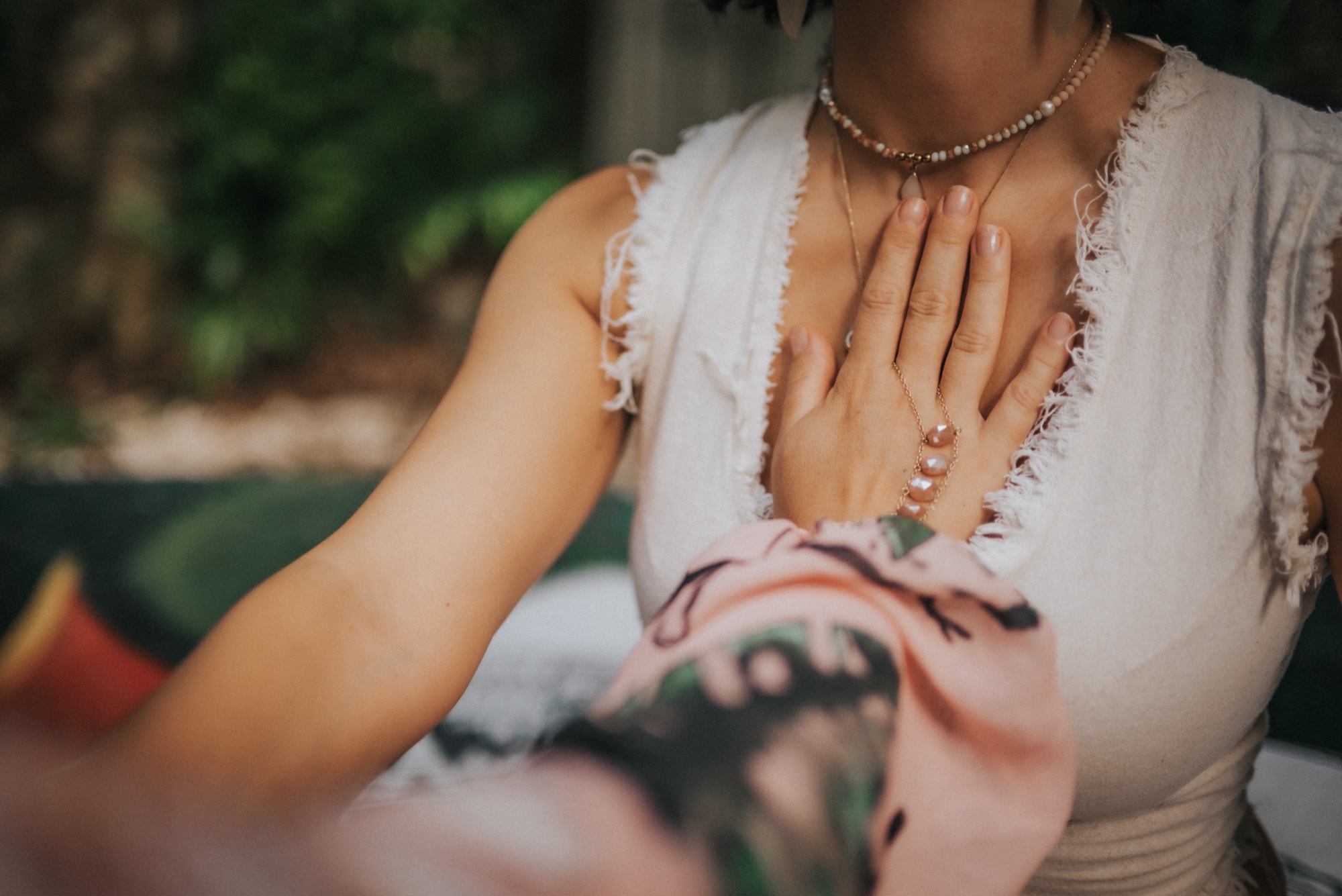 A woman resting a hand on her heart during ceremony