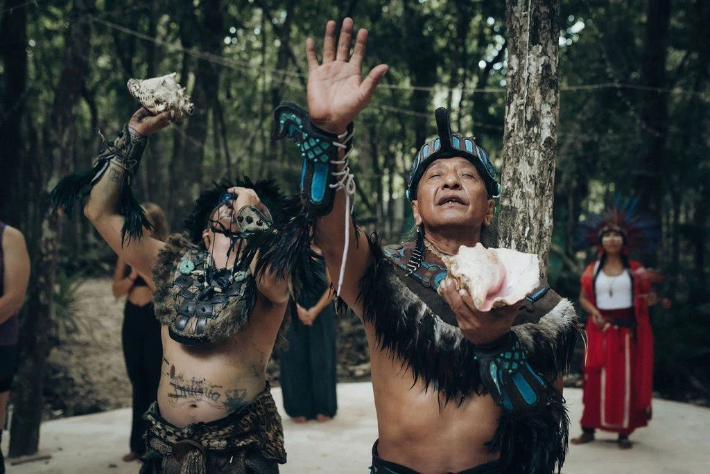 A Mayan blessing ceremony in the jungle — elders sounding conch shells