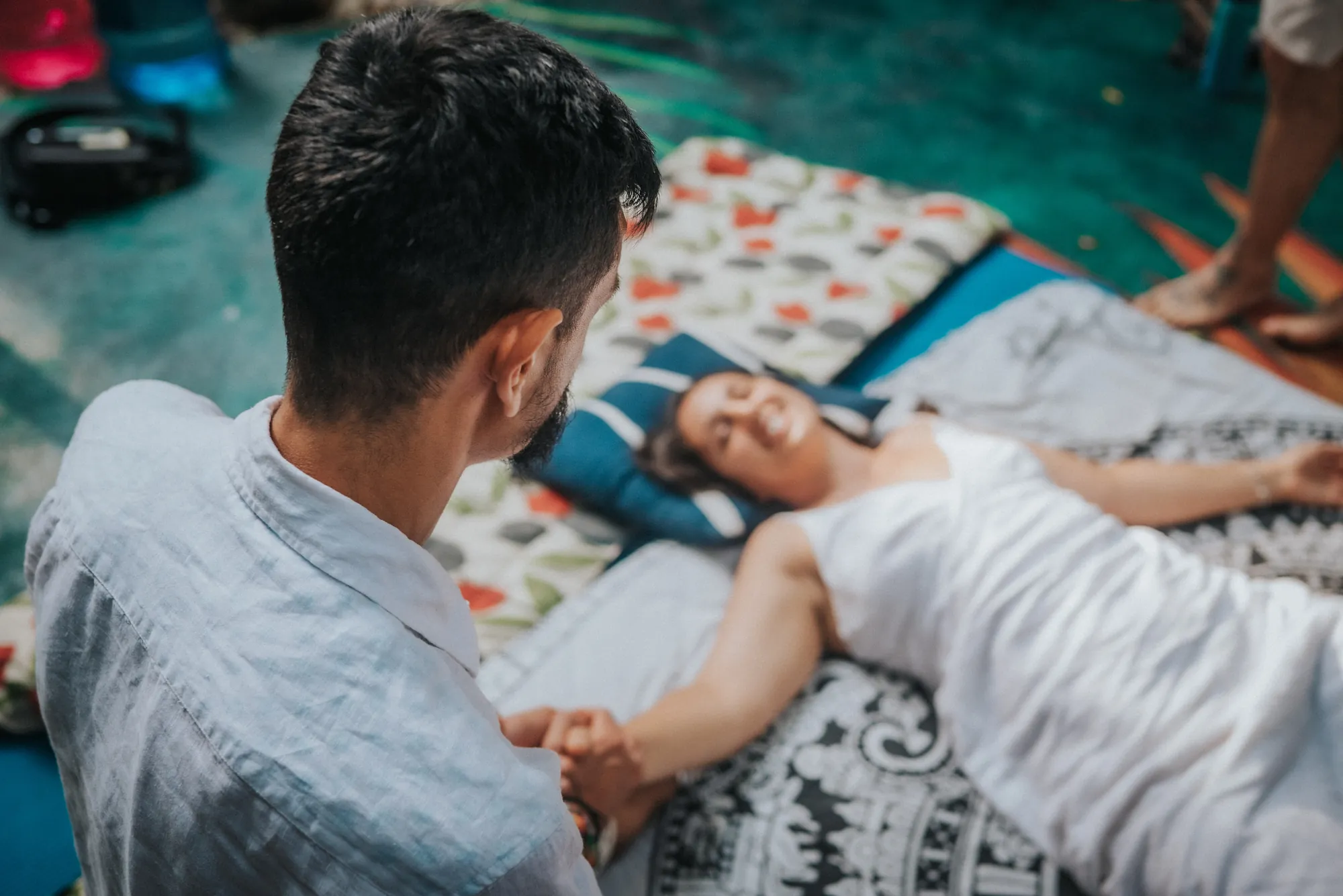 A facilitator holding someone gently through a ceremony